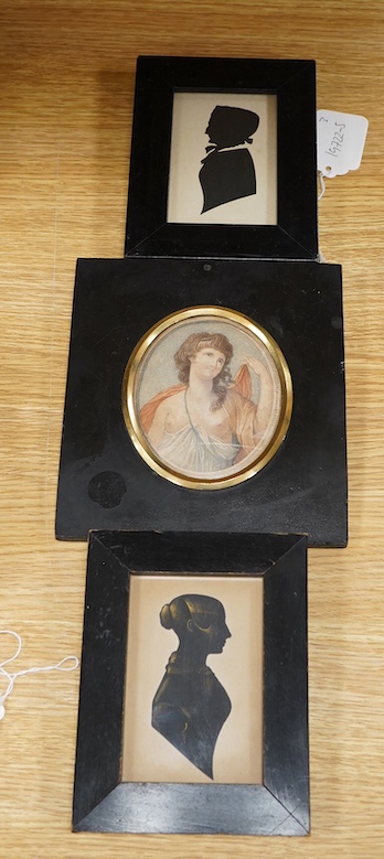 Two early 19th century cut-paper silhouette portraits of ladies, together with a stipple engraving, Portrait of a semi-nude woman, largest 10 x 8.5cm, each housed in ebonised frames